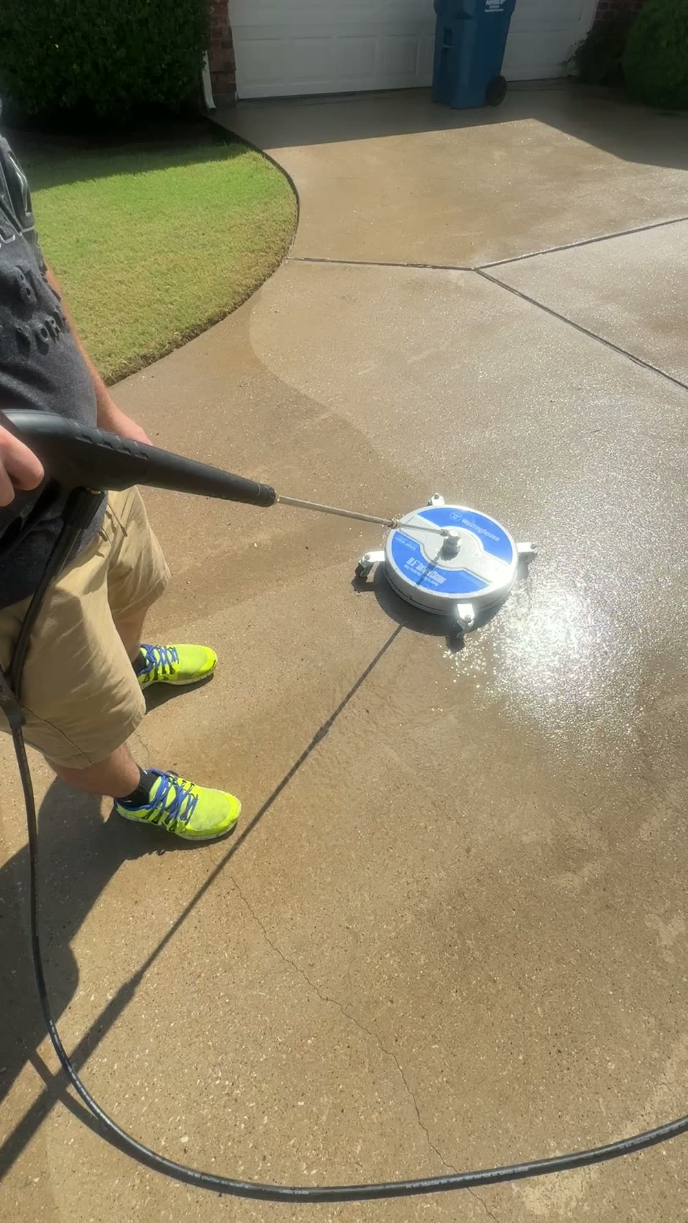 Total Surface Care technician washing a curved residential driveway