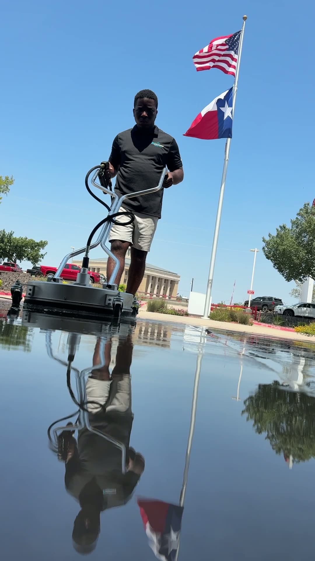 Total Surface Care technician washing a large concrete surface in the Dallas-Fort Worth area